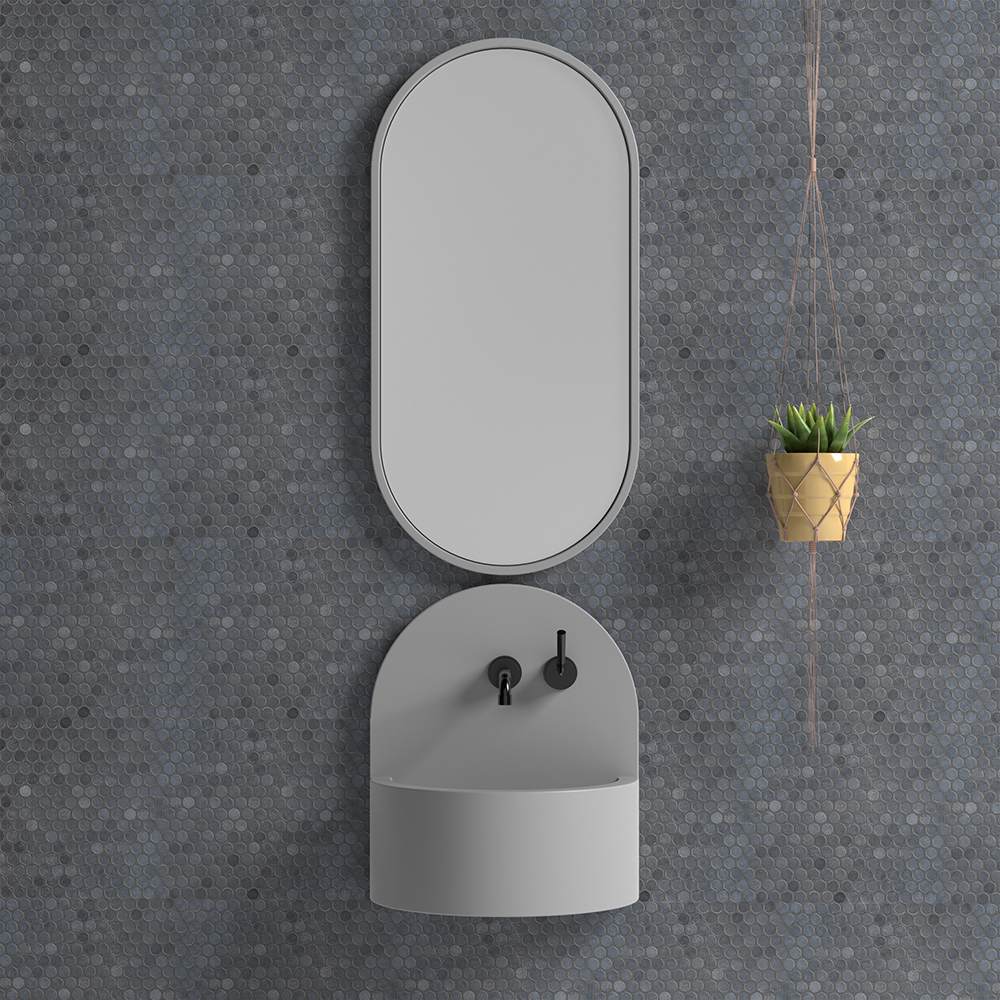 Speckled black basalt wall finish behind a wall-hung washbasin