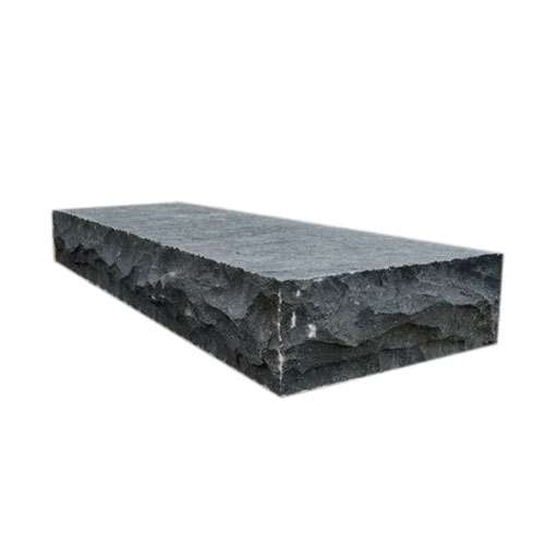 Black basalt step block with a honed top and rock-faced front edge